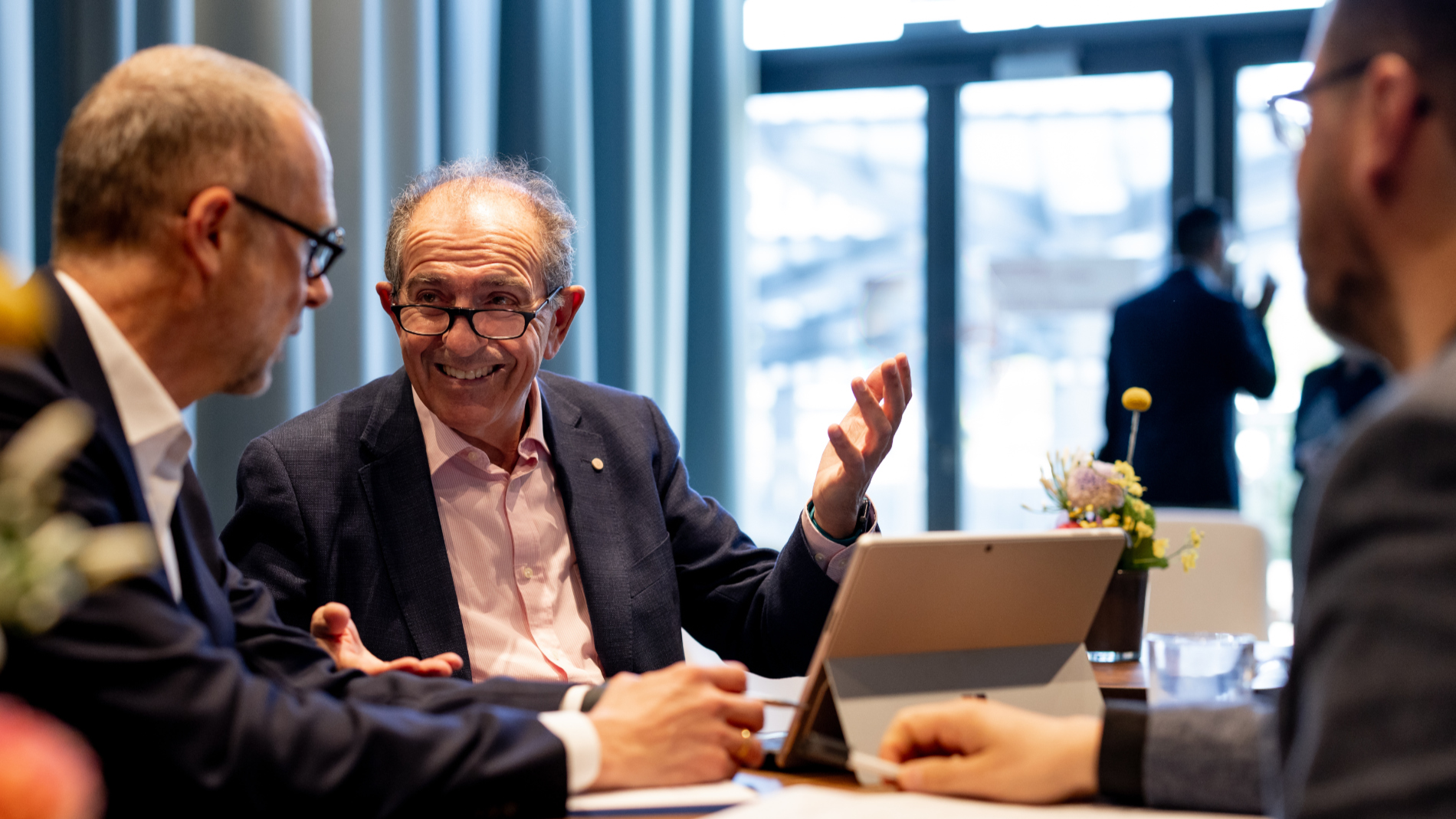 Three men are chatting in the Business Club
