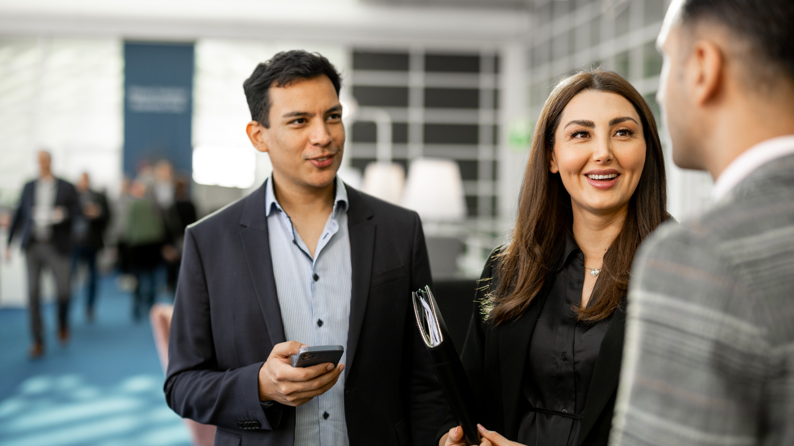 Two men and a woman are talking to each other