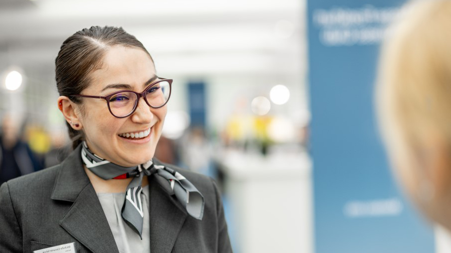 A woman smiles at a visitor.